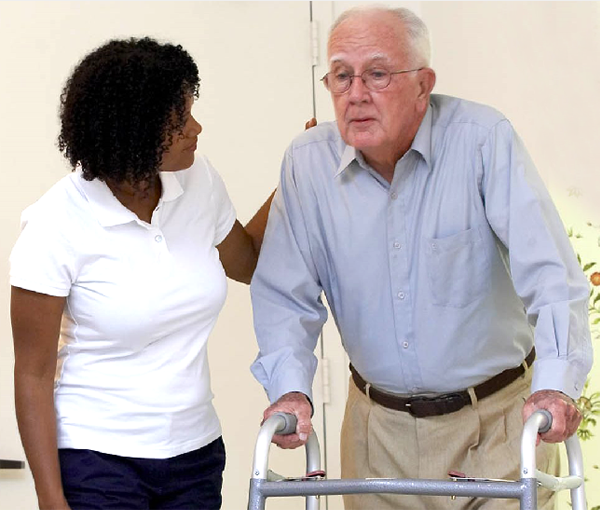 man-wilth-a-walker-being-helped-by-a-care-provider man wilth a walker being helped by a care provider