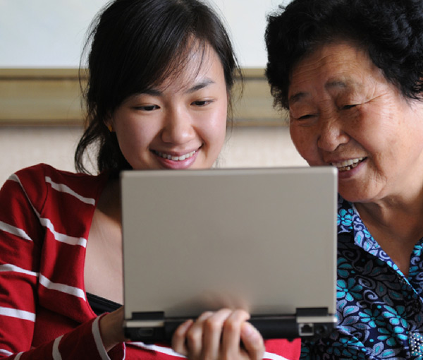 grandmother-and-grandaughter-looking-at-a-computer-screen grandmother and grandaughter looking at a computer screen