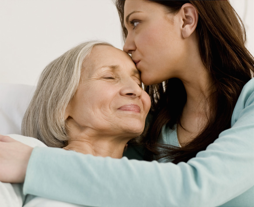 Daughter-hugging-and-kissing-elderly-mother-that-is-laying-in-a-hospital-bed Daughter hugging and kissing elderly mother that is laying in a hospital bed